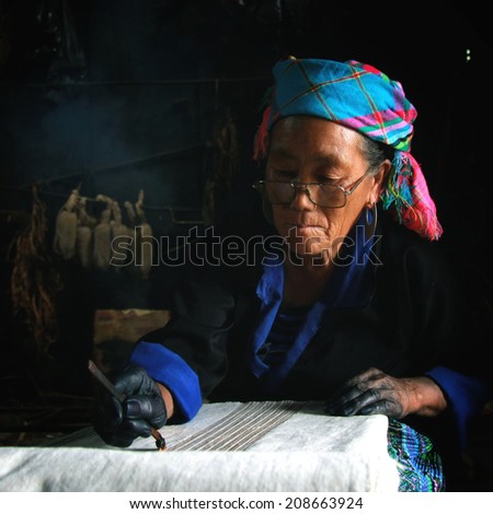 Dien Bien Phu, Dien Bien, Vietnam August 1, 2014: The H'mong ethnic women in the high mountains of decorative painting on canvas, this is one of their traditional occupation.