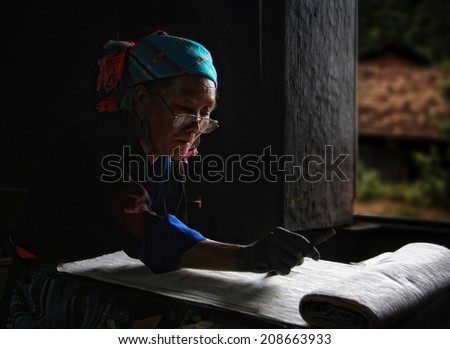 Dien Bien Phu, Dien Bien, Vietnam August 1, 2014: The H'mong ethnic women in the high mountains of decorative painting on canvas, this is one of their traditional occupation.