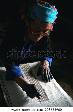 Dien Bien Phu, Dien Bien, Vietnam August 1, 2014: The H'mong ethnic women in the high mountains of decorative painting on canvas, this is one of their traditional occupation.