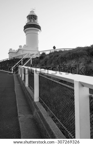 Black and white photo of the iconic cape byron lighthouse on top of a hill Black and white photo of the iconic cape byron lighthouse on top of a hill