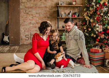 Christmas family portrait in home holiday living room kids and dog play present gift Christmas family portrait in home holiday living room kids and dog play present gift