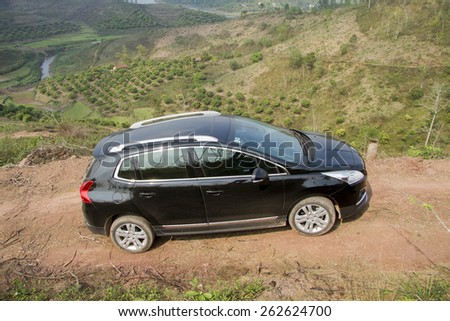 Bac Giang, Viet Nam - March 17, 2015: A SUV Peugeot 3008 car running on the mountain road in Vietnam