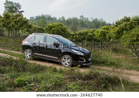 Bac Giang, Viet Nam - March 17, 2015: A SUV Peugeot 3008 car running on the mountain road in Vietnam