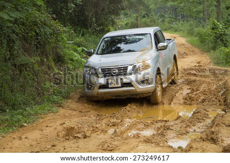 Tuyen Quang, Viet Nam - April 23, 2015: Nissan NP300 Navara car running on the mud road in Vietnam