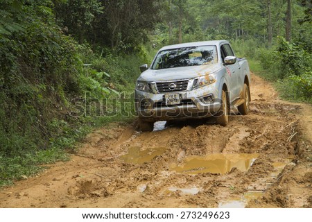 Tuyen Quang, Viet Nam - April 23, 2015: Nissan NP300 Navara car running on the mud road in Vietnam