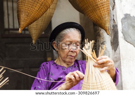 Hungyen, Vietnam - July 26, 2015:Unidentified woman was weaving bamboo in HungYen, Vietnam. Weaving this tools that used to catch fish is traditional occupation in Hung Yen province.