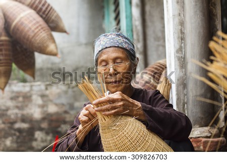 Hungyen, Vietnam - July 26, 2015:Unidentified woman was weaving bamboo in HungYen, Vietnam. Weaving this tools that used to catch fish is traditional occupation in Hung Yen province.