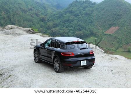 Hoa Binh, Viet Nam - March 27, 2015: Porsche Macan 2015 car running on the mountain road in Vietnam