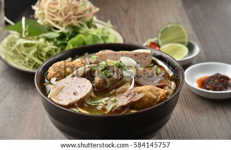 Bun bo Hue - Hue Noodles (Noodles cooked with beef, cooked pork roll, pork meat and eat along with bean sprout, vegetable, banana branch...)