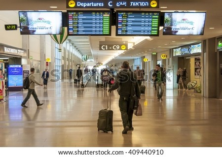 Passenger looking at the departure information board prior to his flight in the Ben Gurion International Airport stock image. Tel Aviv, Israel. December 2014.
