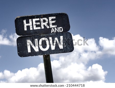 Here and Now sign with clouds and sky background - stock photo