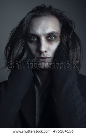 stock-photo-deranged-caucasian-male-long-hair-crazy-eyes-and-pale-skin-british-gothic-495184156.jpg