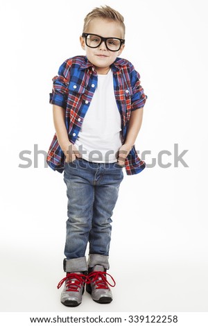 Funny child.fashionable little boy in glasses, jeans, white t-shirt and plaid shirt.stylish kid in sport shoes. fashion children