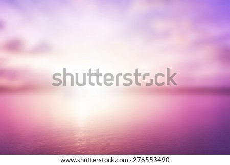 Peaceful concept: Abstract blur beautiful purple ocean with pink sky sunset background.