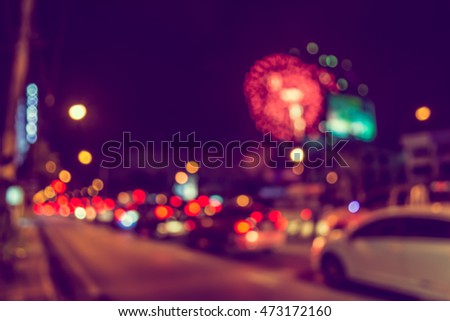 vintage tone blur image of car on street with firework in background night time.