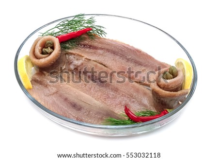 Fillets of herring / anchovies in glass plate,white background.