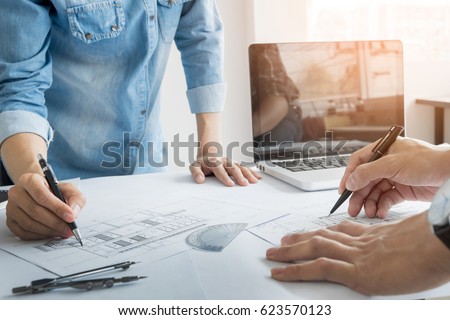 Architects engineer discussing at the table with blueprint - Closeup on hands and project print, Team group on construciton site check documents and business workflow.