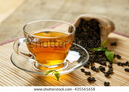 Tea and leaves tea on bamboo placemat