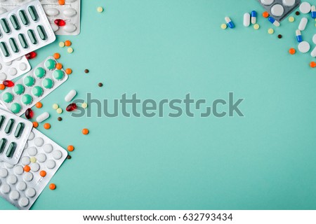 Supplements and pills blister packs, close-up. Place to insert your text, blue background. Pharmacists and clinics.