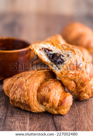Bite Chocolate Croissant With A Cup Of Coffee French Baking On Wooden Board Bite Chocolate Croissant With A Cup Of Coffee French Baking On Wooden Board