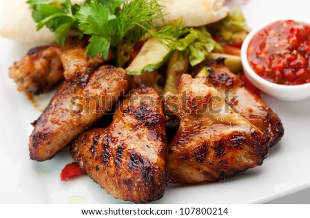 Hot Meat Dishes - Grilled Chicken Wings with Red Spicy Sauce - stock photo
