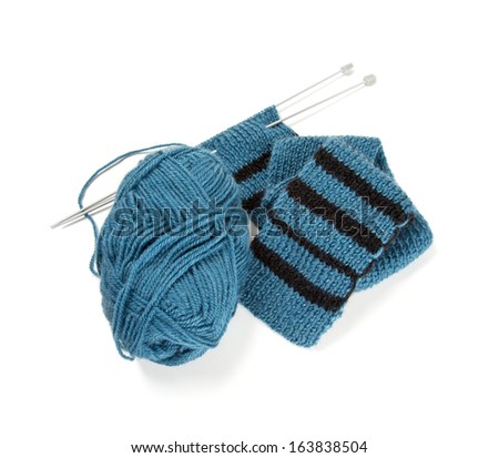 striped scarf on knitting needles over white - stock photo