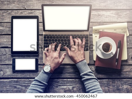 Top view of writer's workplace - laptop and tablet pc with cup of coffee. Clipping paths included.