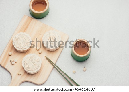 Retro vintage style Chinese mid autumn festival foods. Traditional mooncakes on table setting