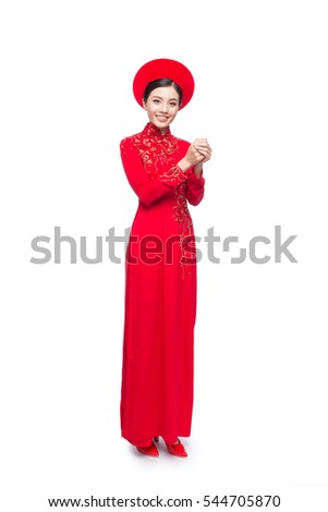 Young vietnamese woman in Ao Dai Dress with praying gesture wishing you good luck