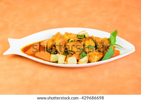 Plate of Cod or Pollack Fish Fillet Stewed in Tomato and Thai Sauce
