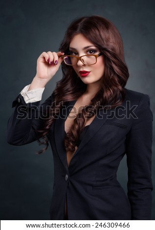 https://thumb1.shutterstock.com/display_pic_with_logo/2573269/246309466/stock-photo-sexy-business-woman-in-a-dark-business-suit-beautiful-sexy-secretary-on-a-dark-background-246309466.jpg