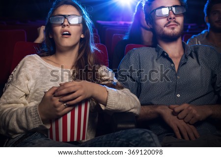 https://thumb1.shutterstock.com/display_pic_with_logo/2574358/369120098/stock-photo-young-teenagers-at-the-cinema-wearing-glasses-and-watching-a-d-movie-a-girl-is-eating-popcorn-369120098.jpg