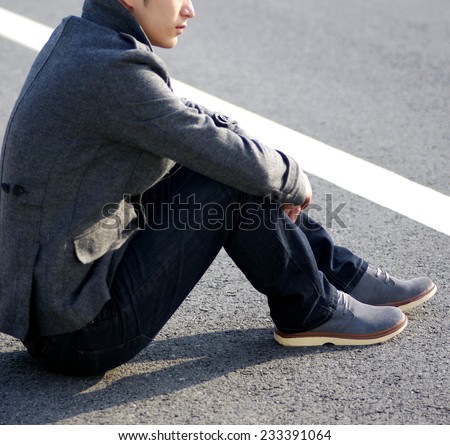 Human foot with brown leather shoes and jeans - stock photo