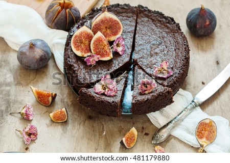 Chocolate Cake With Fresh Figs And Candied Flowers On Old Wooden Background Selective Focus Chocolate Cake With Fresh Figs And Candied Flowers On Old Wooden Background Selective Focus
