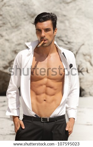 stock-photo-sexy-male-model-in-open-shirt-exposing-great-toned-muscular-body-and-abs-107595023.jpg