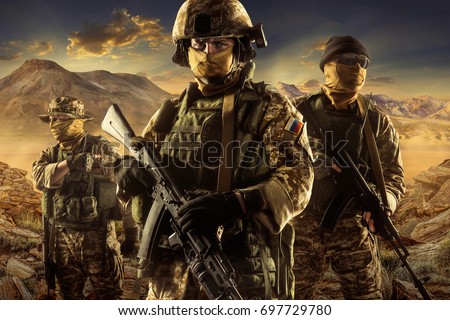 Three soldiers of russian mechanized infantry in desert of middle east