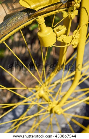 stock-photo-yellow-painted-bicycle-detail-with-front-wheel-dynamo-system-spokes-and-axle-in-bright-summer-453867544.jpg