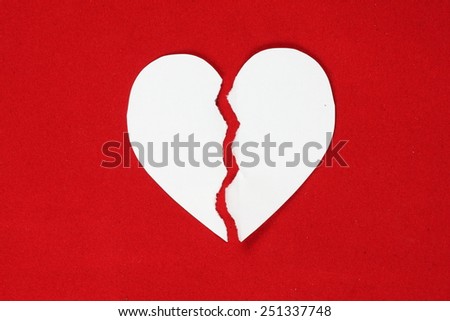 White Paper Heart Torn In Half on red background - stock photo