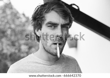 Portrait of handsome man smoking black and white pictures Portrait of handsome man smoking black and white pictures