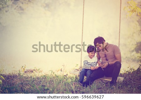 Vintage color photo happy joyful father having fun and son, family, travel, father's day - concept. Sunlight