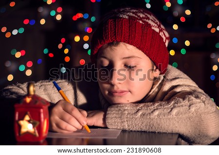 The child writes a letter to Santa Claus. Christmas expectation