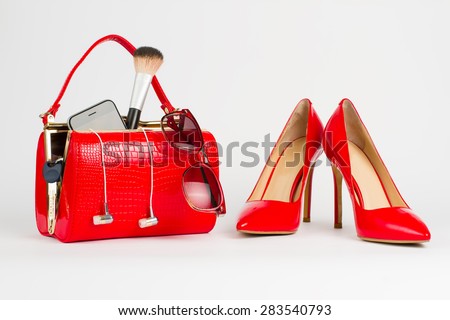 Red women's handbag. Things from open lady handbag.