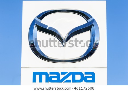 Gdansk, Poland - July 25, 2016: Logo of a japanese car manufacturer Mazda against a blue sky.