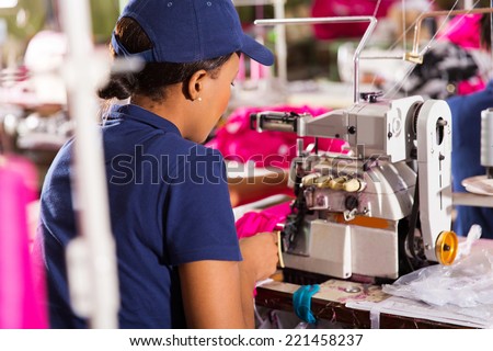 rear view of textile worker sewing