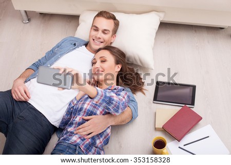 https://thumb1.shutterstock.com/display_pic_with_logo/2711341/353158328/stock-photo-cute-young-married-couple-is-making-selfie-at-home-they-are-lying-on-flooring-and-smiling-the-353158328.jpg