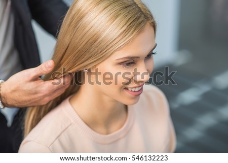 Smiling girl is sitting at the salon