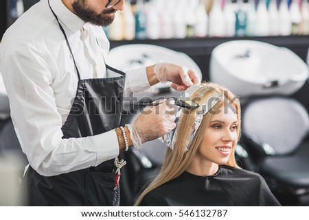 Happy woman is sitting at salon