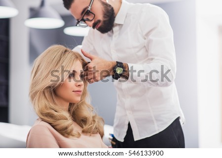 Confident young woman is looking at her reflection