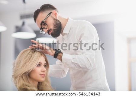 Serious man with beard at hairdresser salon
