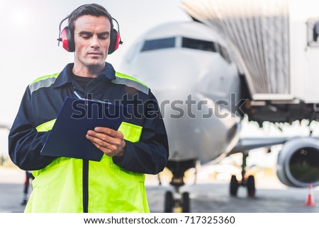 Serious male worker noting data